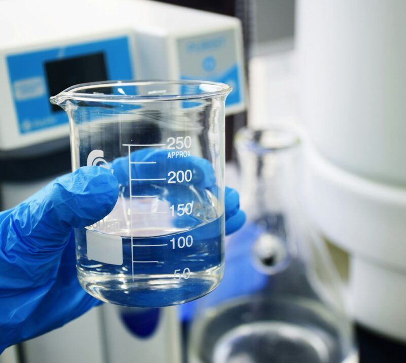 clear glass measuring cup on white table