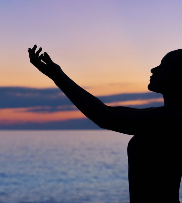 silhouette of woman raising her right hand